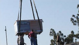 Team Using A Crane To Lift Heavy Objects